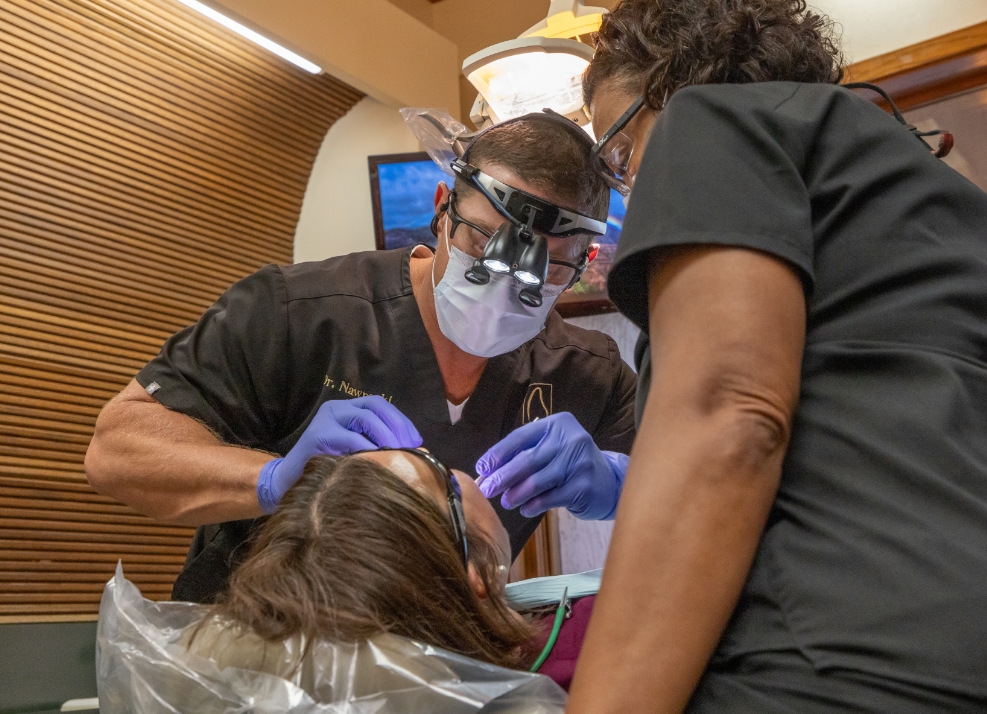 Ormond dentist and assistant wearing protective gear while treating a dental patient