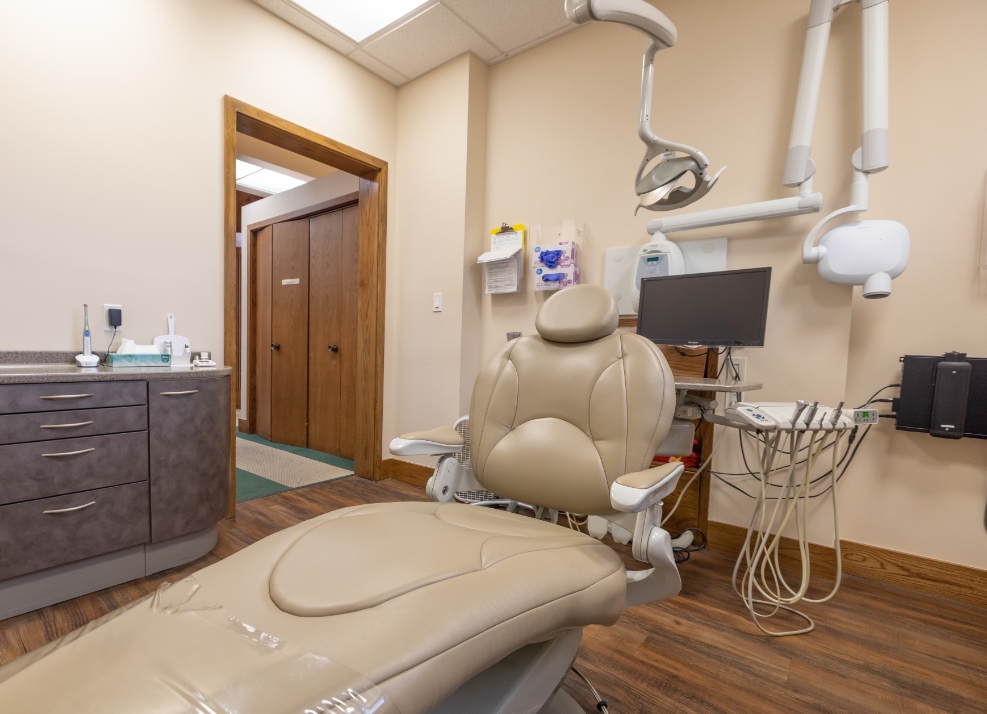 Dental exam chair with computer in background