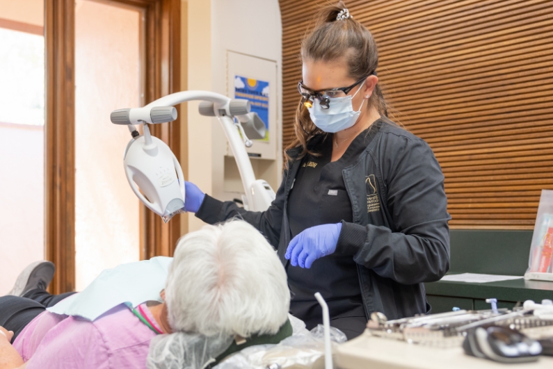 Dentist performing a preventive dentistry exam on a patient