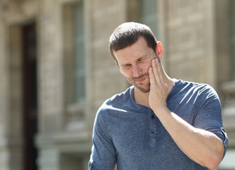 Man standing outside with jaw pain from TMJ disorder in Ormond Beach, FL