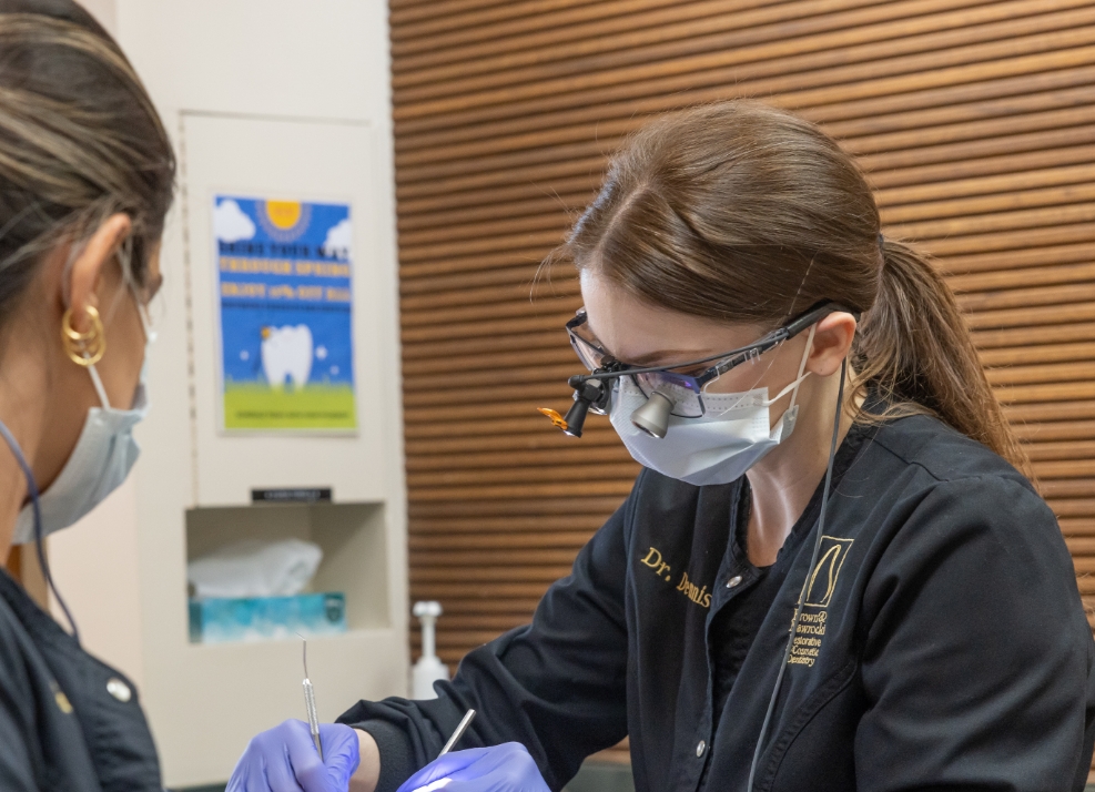 Doctor Dennis wearing protective gear while treating a dental patient