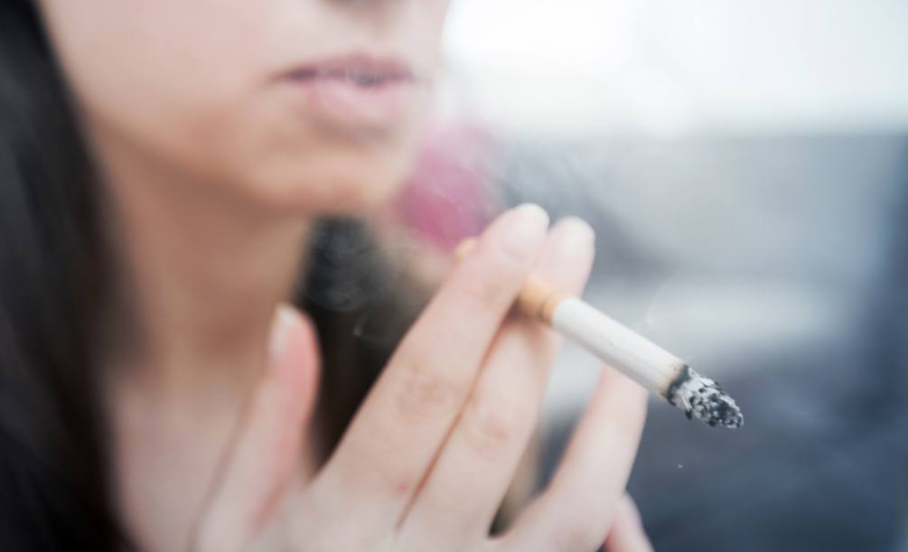 Close up of person smoking a cigarette