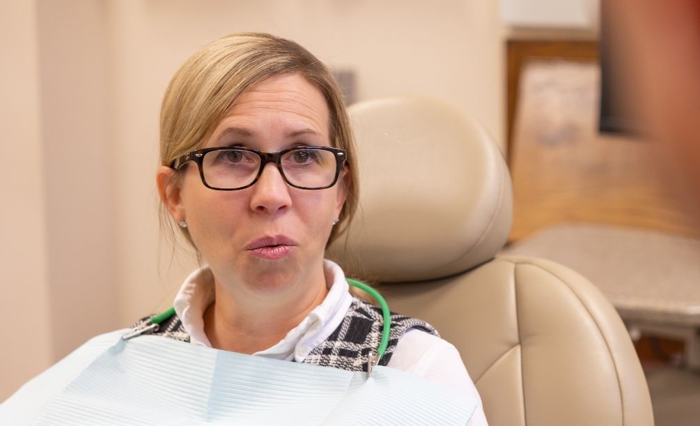 Blonde woman sitting in dental chair during dental checkup