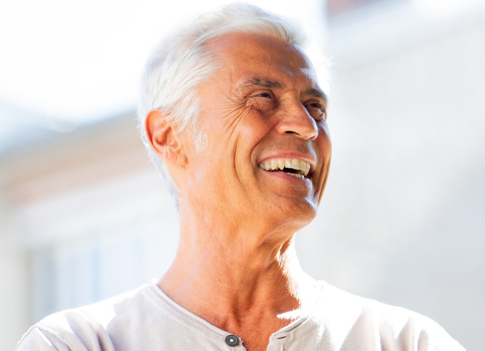 Senior man in white shirt smiling