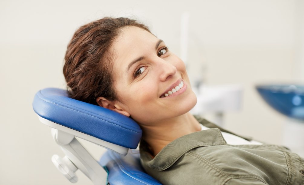 Woman smiling while leaning back in dental chair