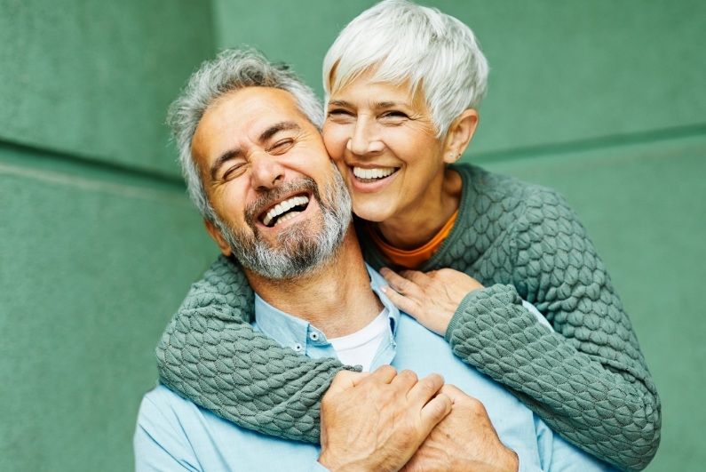 Smiling older man and woman with dentures in Ormond Beach