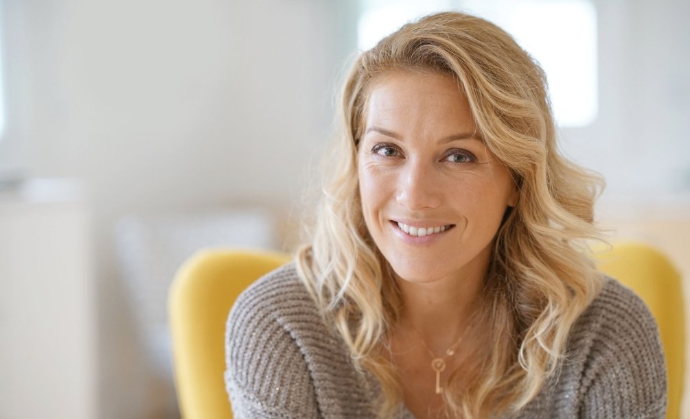 Blonde woman in beige sweater