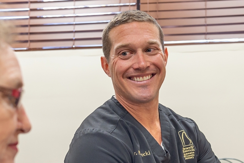 Ormond Beach Florida prosthodontist Doctor Andrew Nawrocki smiling at dental patient