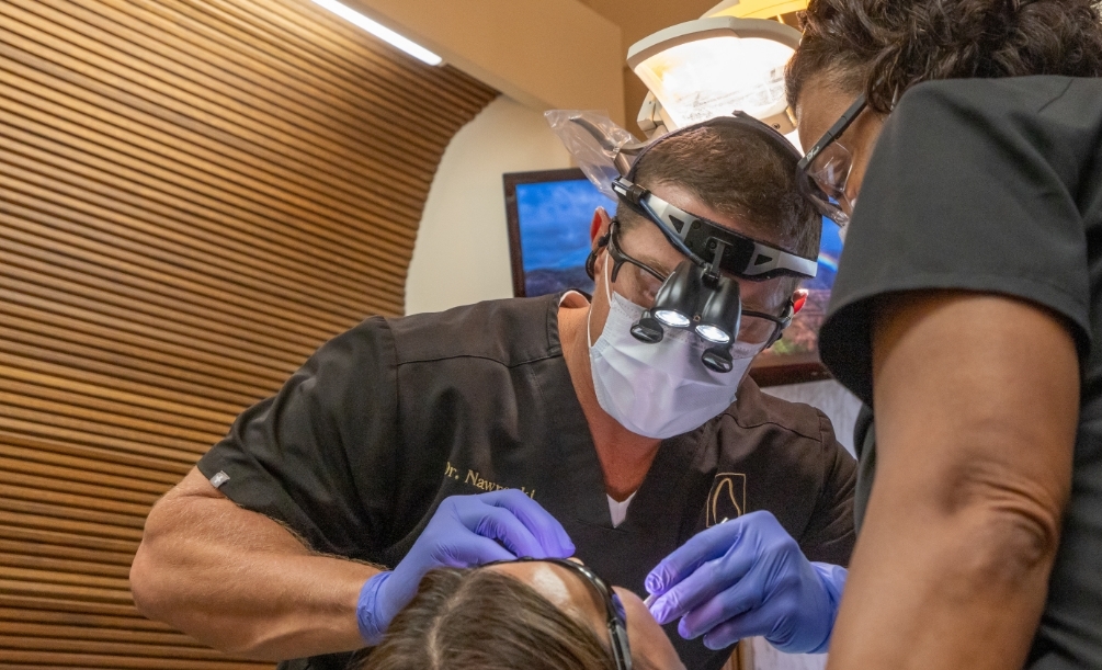 Doctor Nawrocki wearing protective equipment while treating a dental patient