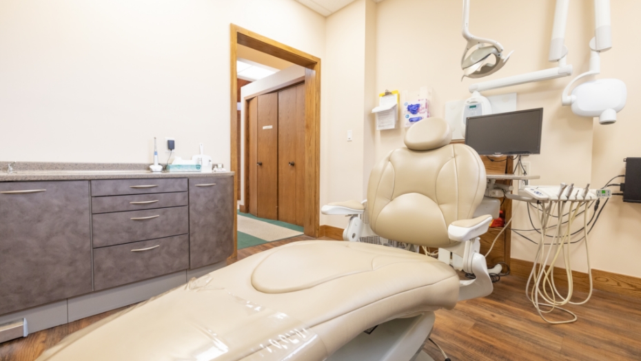 Dental treatment room with hallway visible through open door