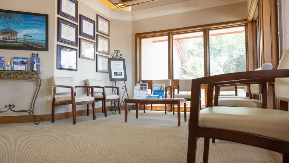 Wooden chairs and table in dental office waiting room