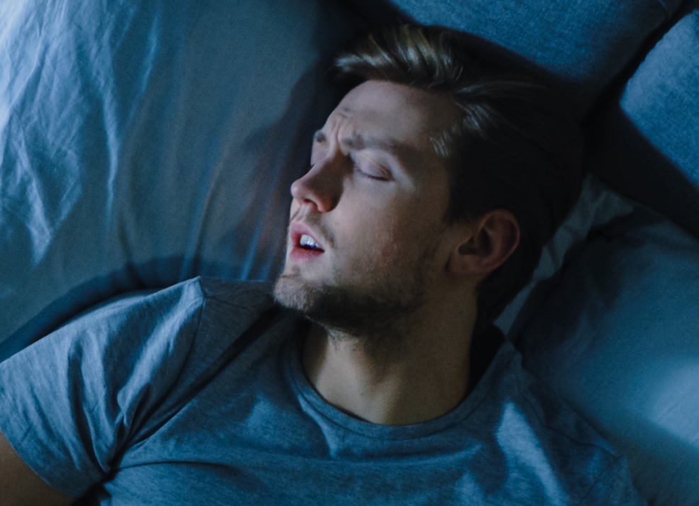 Man sleeping on his back with his mouth open