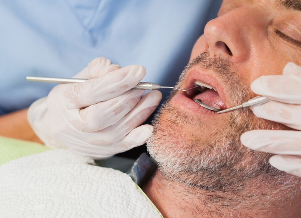 Close up of man receiving treatment from sedation dentist in Ormond Beach