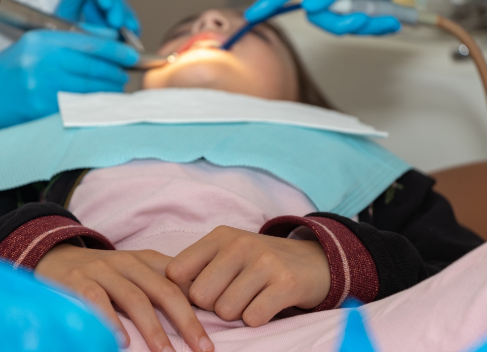 Young woman relaxing while receiving dental treatment