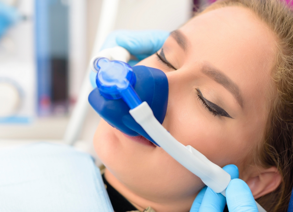 Young woman wearing nitrous oxide sedation dentistry mask