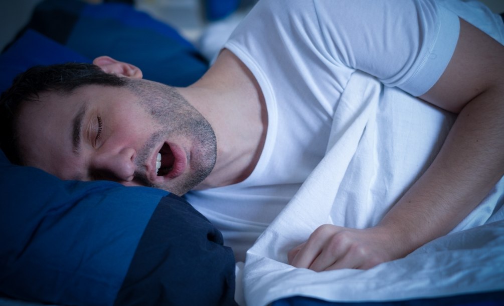 Man sleeping on his side with his mouth open