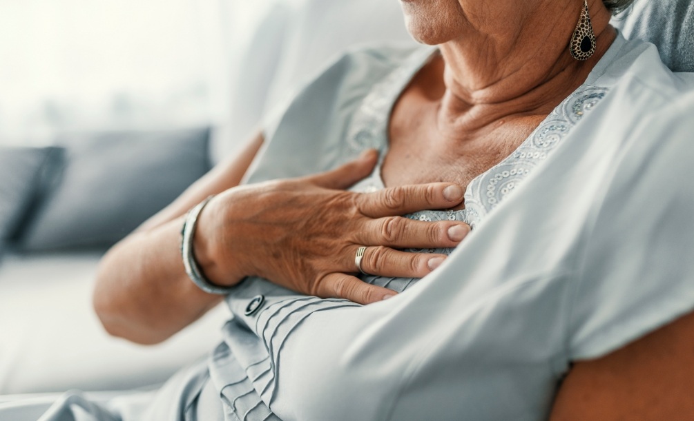 Close up of senior woman with her hand over her heart