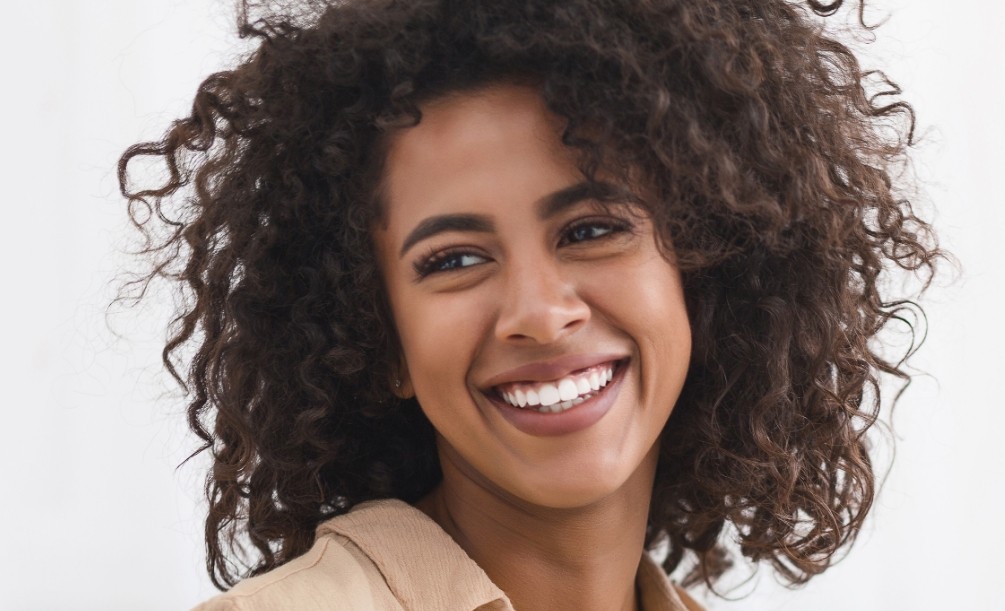 Woman in brown coat grinning