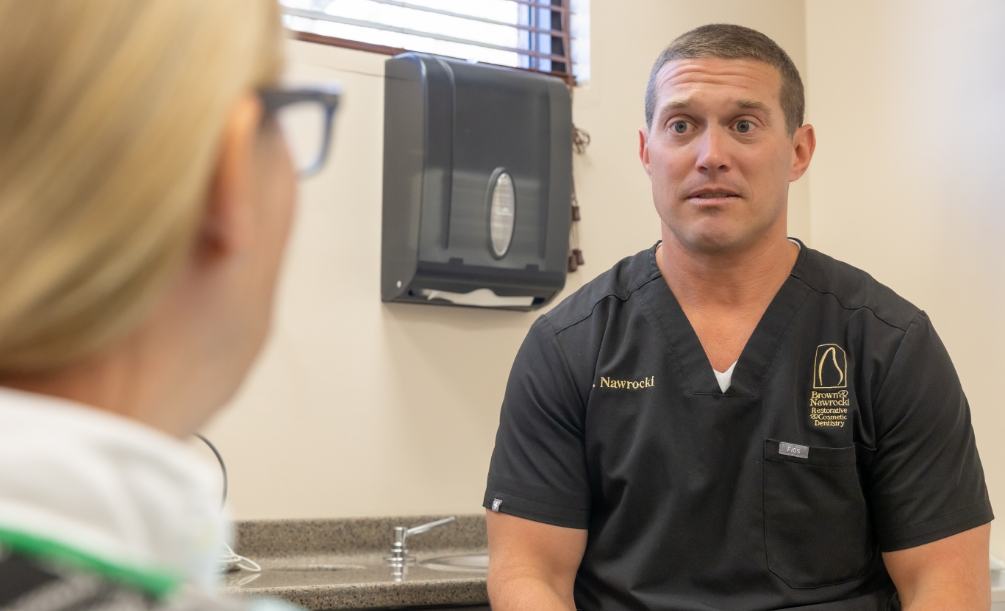 Doctor Nawrocki talking with dental patient