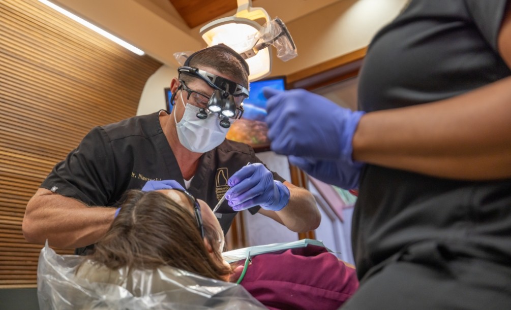 Doctor Nawrocki performing a tooth extraction