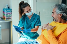 a patient talking to his dentist about wisdom tooth extractions