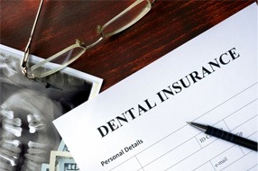 a dental insurance form next to an X-ray