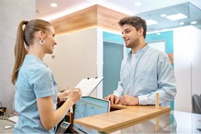 a patient discussing affordable wisdom tooth extractions