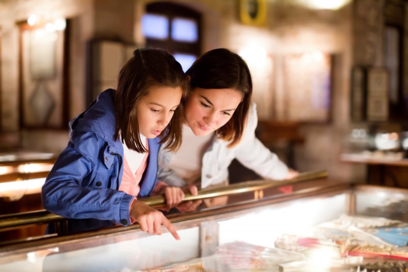 A mother and daughter looking at a museum display